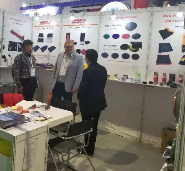 Chris Jiang, a magician for Brilliatech, spoke with customers about magic clay bars, magi clay pads, clay balls, mitts, and car cleaning tools on Automechanika Shanghai.